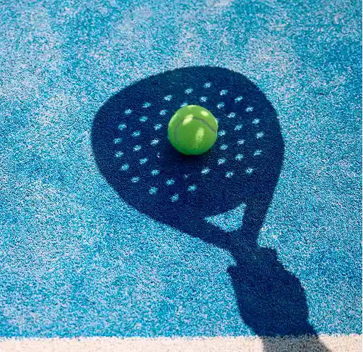 shadow of paddle tennis player hitting the ball on
