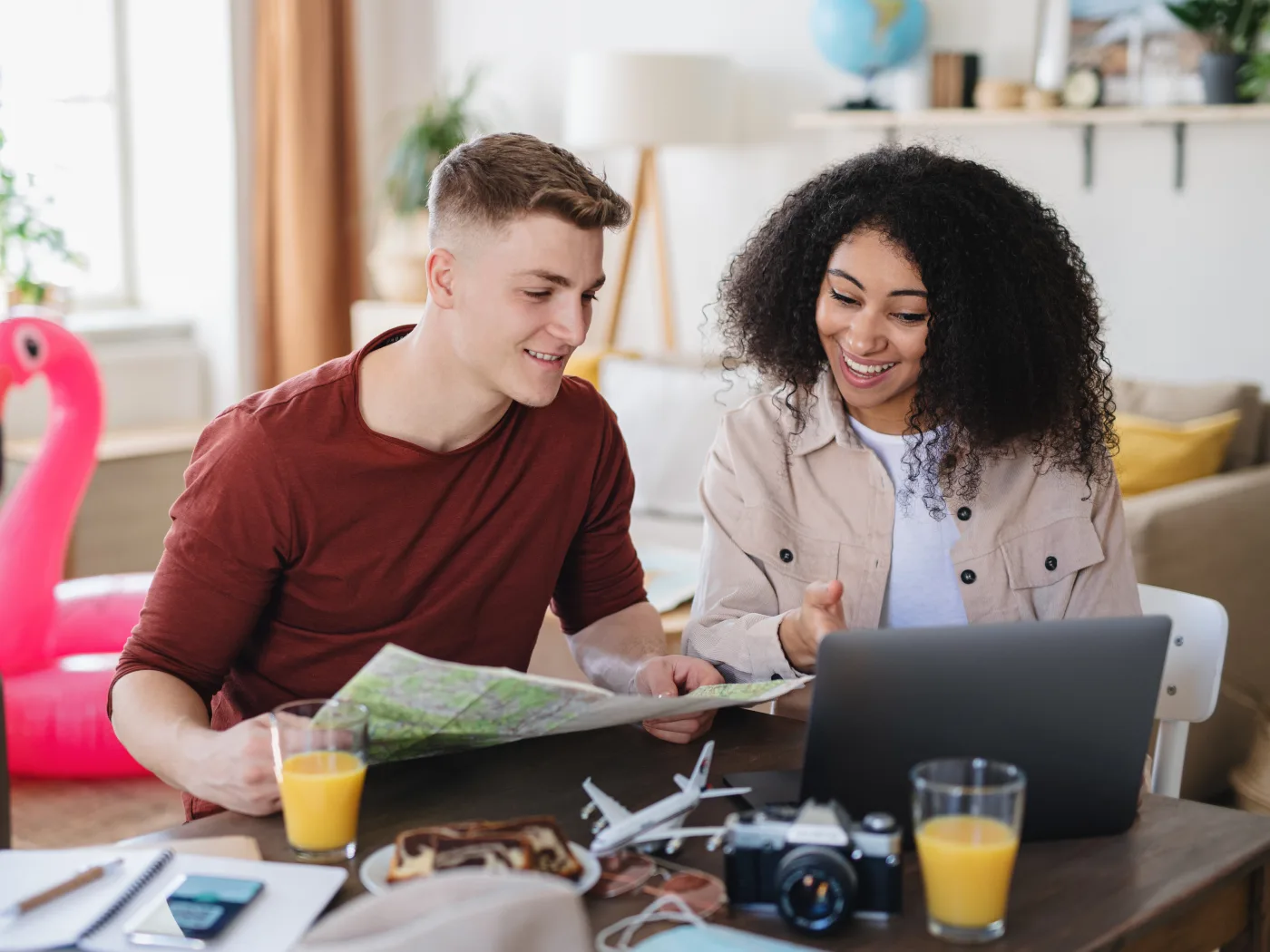 young couple with laptop packing for holiday